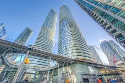 a group of tall buildings in a city at One bed plus Den Downtown Toronto in Toronto
