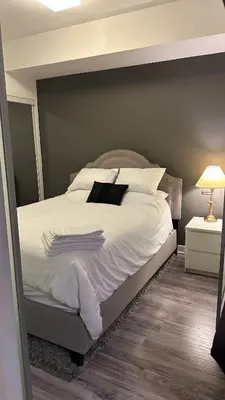 a bedroom with a bed with white sheets and pillows at One bed plus Den Downtown Toronto in Toronto
