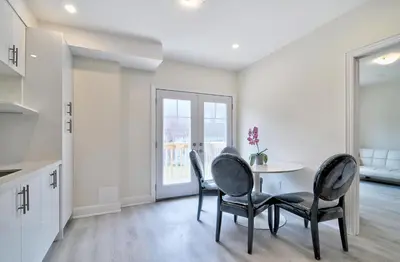 a kitchen and dining room with a table and chairs at 50% discount Amazing 3 Bedrooms Guest Suite in Richmond Hill