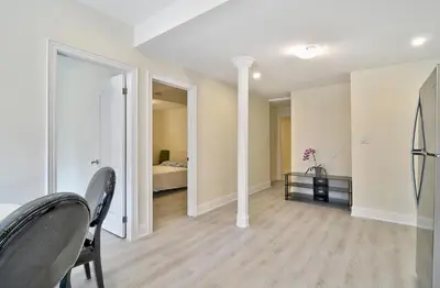 a living room with a bed and a table and chairs at 50% discount Amazing 3 Bedrooms Guest Suite in Richmond Hill