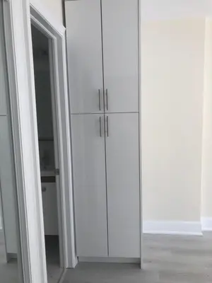 a white cabinet in a room with a door at 50% discount Amazing 3 Bedrooms Guest Suite in Richmond Hill
