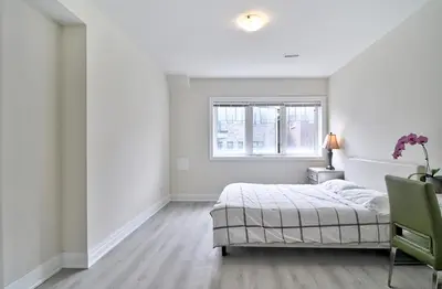 a white bedroom with a bed and a window at 50% discount Amazing 3 Bedrooms Guest Suite in Richmond Hill