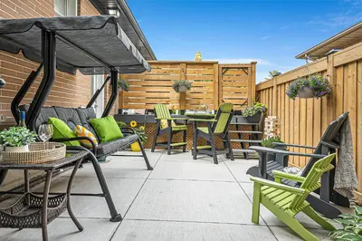 a patio with a table and chairs and an umbrella at Bright 2-Bedroom Apartment in Burlington