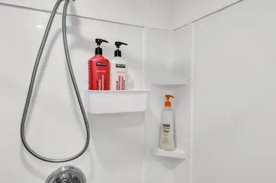 a bathroom with two bottles of soap and a shower at Bright 2-Bedroom Apartment in Burlington