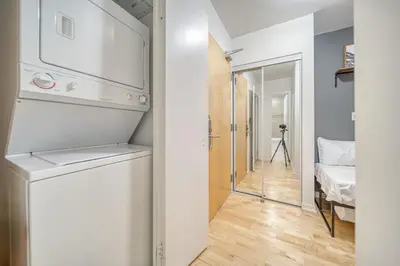 a kitchen with a washer and dryer in a room at GSuite Express Downtown Toronto in Toronto