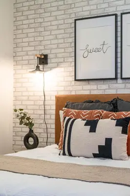 a bedroom with a bed and a brick wall at GSuite Express Downtown Toronto in Toronto