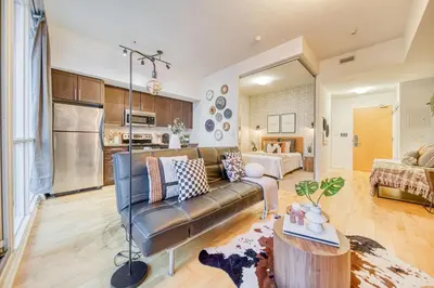 a living room with a couch and a table at GSuite Express Downtown Toronto in Toronto