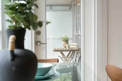 a room with a table with a vase with a plant at Stylish Downtown Toronto Suite with Free Parking in Toronto