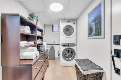 a laundry room with a washer and dryer at Spacious Elegance: Two Living Spaces in One Home in Burlington