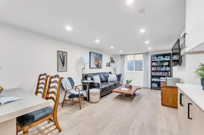 a living room with a couch and a table at Spacious Elegance: Two Living Spaces in One Home in Burlington
