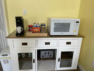 a microwave sitting on top of a white cabinet at Private Suite in Niagara Falls in Niagara Falls