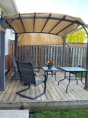 a gazebo with two chairs and a table on a deck at Private Suite in Niagara Falls in Niagara Falls