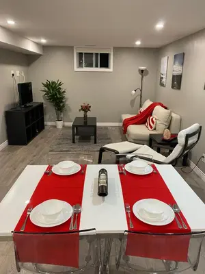 a living room with a table with a red table cloth at Brand new apartment with private entrance and patio in Guelph