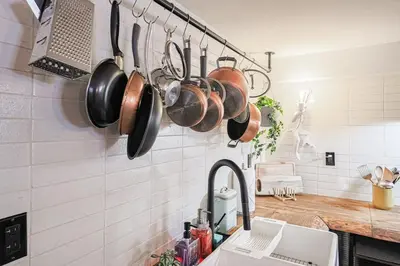 a kitchen with pots and pans hanging from the wall at Spa Oasis in Toronto's Heart-Free Parking! and Pet Friendly in Toronto