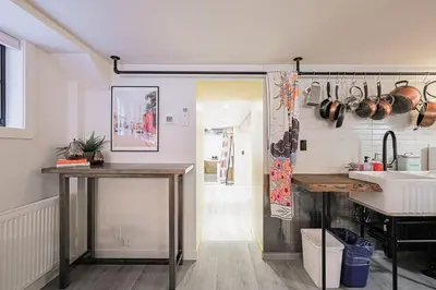 a kitchen with two tables and a sink and a counter at Spa Oasis in Toronto's Heart-Free Parking! and Pet Friendly in Toronto