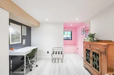 a home office with a desk and a pink wall at Spa Oasis in Toronto's Heart-Free Parking! and Pet Friendly in Toronto