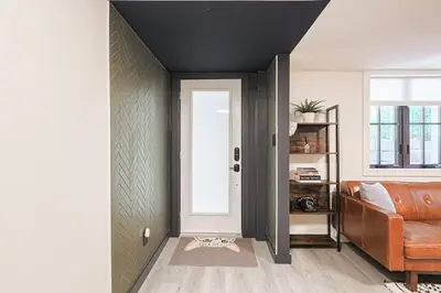 a living room with a door and a couch at Spa Oasis in Toronto's Heart-Free Parking! and Pet Friendly in Toronto