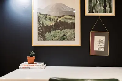 a table with books and a picture on a wall at Spa Oasis in Toronto's Heart-Free Parking! and Pet Friendly in Toronto