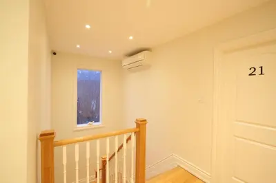 a staircase in a house with the number on the wall at Xiao Wang in Toronto