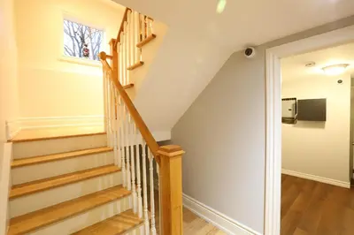 a staircase in a home with wooden floors at Xiao Wang in Toronto