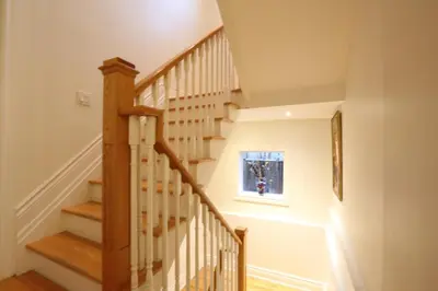 a stairwell with a wooden staircase with a window at Xiao Wang in Toronto