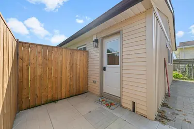 a house with a wooden fence and a door at The Garden Retreat in Welland, On - 1BR,Free Parking and Workspace in Welland