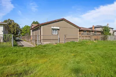 a house with a fence in a yard at The Garden Retreat in Welland, On - 1BR,Free Parking and Workspace in Welland