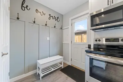 a kitchen with white cabinets and a stove at The Garden Retreat in Welland, On - 1BR,Free Parking and Workspace in Welland