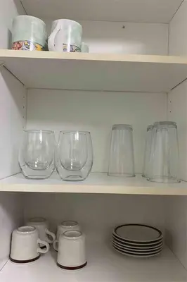 a shelf with glass jars and plates on it at Alaa Aldahhan in Mississauga