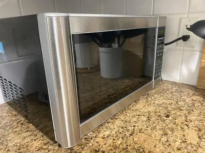 a microwave oven with its door open on a counter at Alaa Aldahhan in Mississauga
