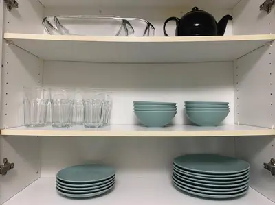 a shelf with plates and glasses on it at Alaa Aldahhan in Mississauga