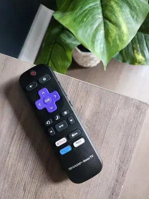 a remote control sitting on top of a table at Queen St West Haven - Modern Loft, Downtown Toronto, Free Parking in Toronto