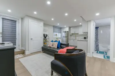 a living room with a couch and a kitchen at 2 Bedroom Private Suite-Parking-Near Hospital and Airport in Oakville