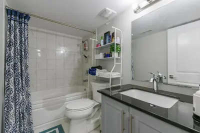 a bathroom with a sink and a toilet and a tub at 2 Bedroom Private Suite-Parking-Near Hospital and Airport in Oakville