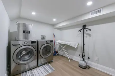 a laundry room with a washer and dryer in it at 2 Bedroom Private Suite-Parking-Near Hospital and Airport in Oakville