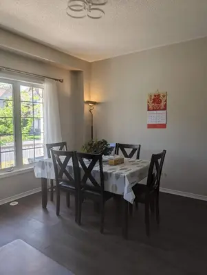 a dining room with a table and chairs and a window at \u65b0\u58f9\u5bb6\u6c11\u5bbf202 in Markham
