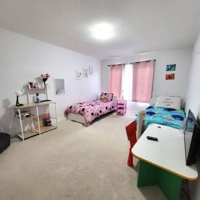 a bedroom with a bed and a table in it at Spacious 4 Bedroom House in Angus in Angus
