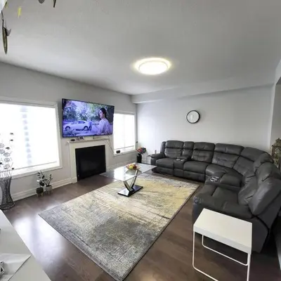 a living room with a couch and a flat screen tv at Spacious 4 Bedroom House in Angus in Angus