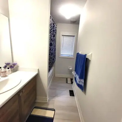 a bathroom with a sink and a blue towel at Spacious 4 Bedroom House in Angus in Angus