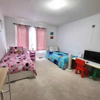 a bedroom with a bed and a desk with a computer at Spacious 4 Bedroom House in Angus in Angus