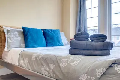 a pile of towels sitting on top of a bed at Brampton Retreat - Quiet 2BR Residential Area in Brampton