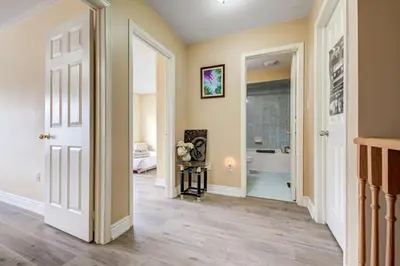 a hallway with a door leading to a bathroom at Brampton Retreat - Quiet 2BR Residential Area in Brampton