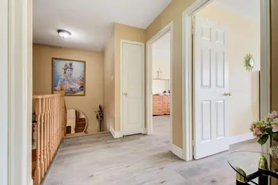a hallway with a white door and a room with a crib at Brampton Retreat - Quiet 2BR Residential Area in Brampton