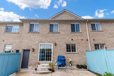 a brick house with a blue chair in front of it at Brampton Retreat - Quiet 2BR Residential Area in Brampton