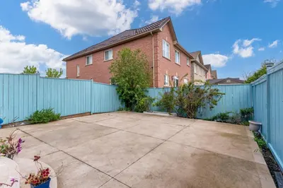 a brick house with a blue fence at Brampton Retreat - Quiet 2BR Residential Area in Brampton