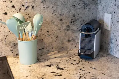 a kitchen counter with a blender and a cup of utensils at RentX Downtown 2-Bed Suite Gym WiFi in Toronto