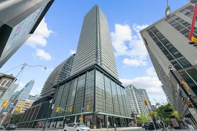 a tall building on a city street with at RentX Downtown 2-Bed Suite Gym WiFi in Toronto