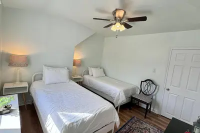 a bedroom with two beds and a ceiling fan at Near the Falls Two Bedroom - 5 min Walk to Clifton in Niagara Falls