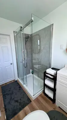 a bathroom with a glass shower and a toilet at Near the Falls Two Bedroom - 5 min Walk to Clifton in Niagara Falls