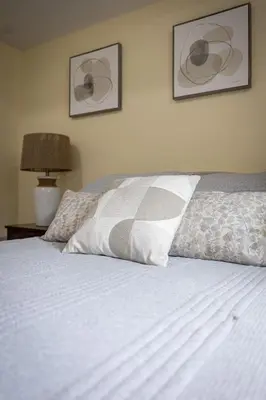 a bed with a pillow on top of it at Elegant & Private Apartment - Short Walk From Downtown in London